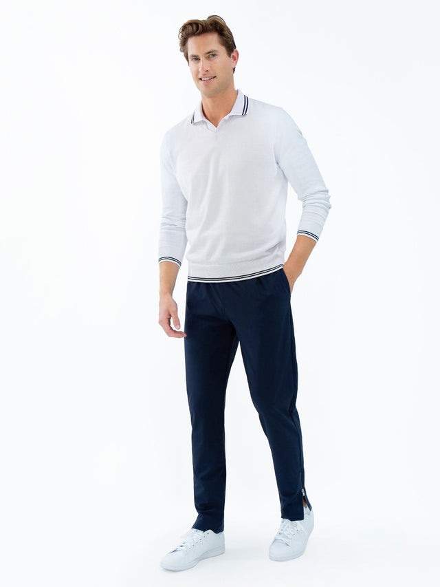 Man wearing inphorm classic cotton "V" neck sweater in white with blue stripes cuff and bottom hem  front  full view.