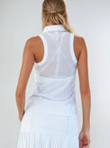 Woman wearing Neisha Classic Sleeveless Polo in white with silver zip and mesh shoulder inserts, demonstrating the semi-fitted design and ventilation features of this moisture-wicking golf shirt | Back View
