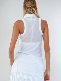 Woman wearing Neisha Classic Sleeveless Polo in white with silver zip and mesh shoulder inserts, demonstrating the semi-fitted design and ventilation features of this moisture-wicking golf shirt | Back View