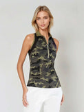 Woman wearing Neisha Classic Sleeveless Polo in camo with silver zip and mesh shoulder inserts, demonstrating the semi-fitted design and ventilation features of this moisture-wicking golf shirt | Front view slightly tilted body.