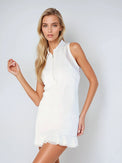 Woman wearing semi-fitted classic dress with silver front zipper, self-fabric collar, and sheer mesh inserts at shoulders and back, showcasing its elegant silhouette and performance features for athletic wear.  Front 3/4 view.