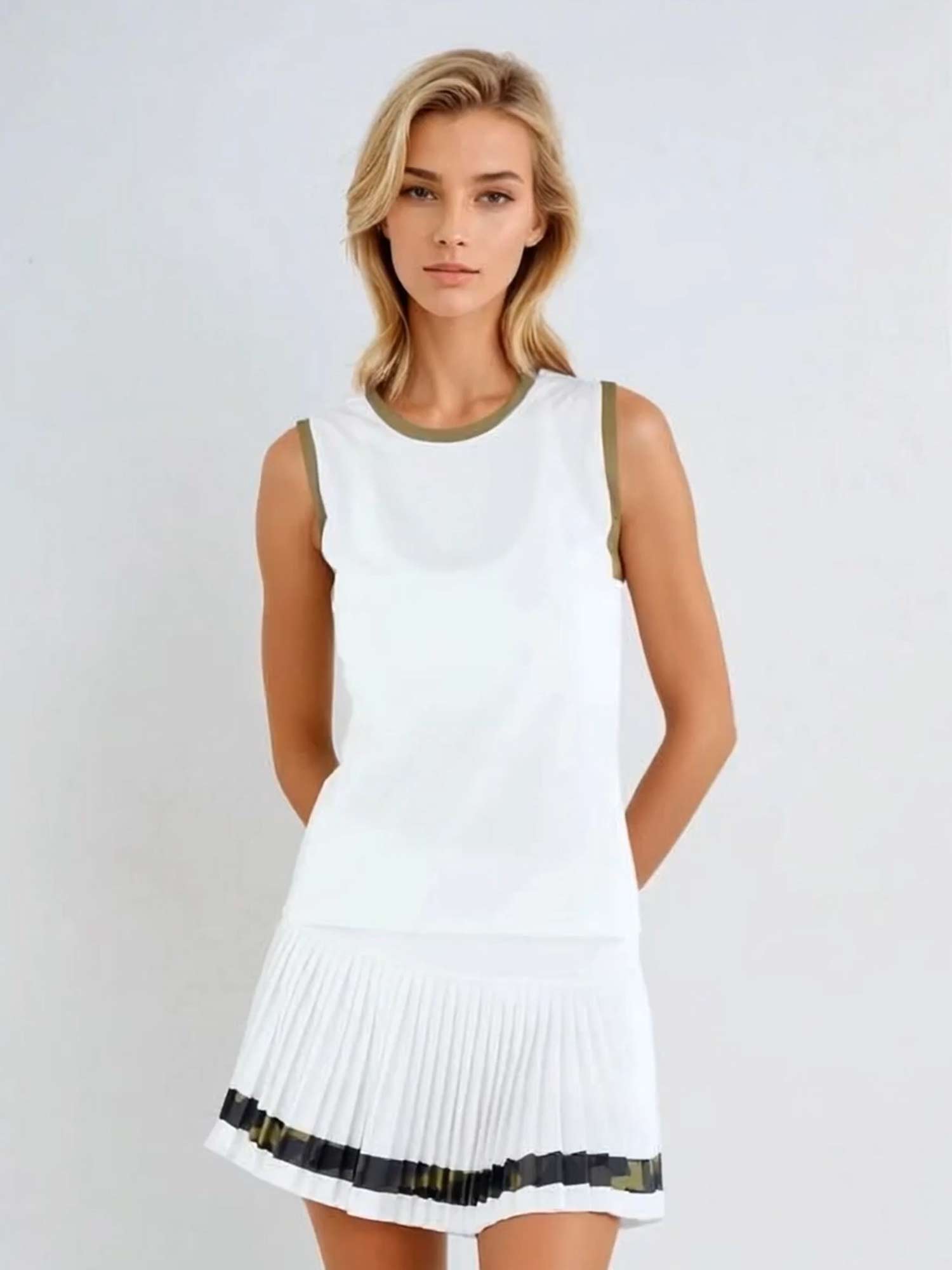 Woman wearing Harper Tank in a relaxed fit with retro-inspired color blocking and contrast accents, showcasing the crew neckline and athletic design suitable for both tennis and casual wear - front view
