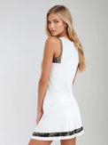 Woman wearing Harper Tank in a relaxed fit with retro-inspired color blocking and contrast accents, showcasing the crew neckline and athletic design suitable for both tennis and casual wear - side back view