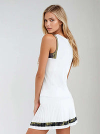 Woman wearing Harper Tank in a relaxed fit with retro-inspired color blocking and contrast accents, showcasing the crew neckline and athletic design suitable for both tennis and casual wear - side back view