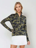 Woman wearing fitted camo print half-zip performance top with gold collar accents, thumbhole sleeves, and silver zipper detail, showcasing the versatile high collar design suitable for athletic and casual wear - front view with hand at the waist