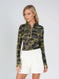 Woman wearing fitted camo print half-zip performance top with gold collar accents, thumbhole sleeves, and silver zipper detail, showcasing the versatile high collar design suitable for athletic and casual wear - front view shorts