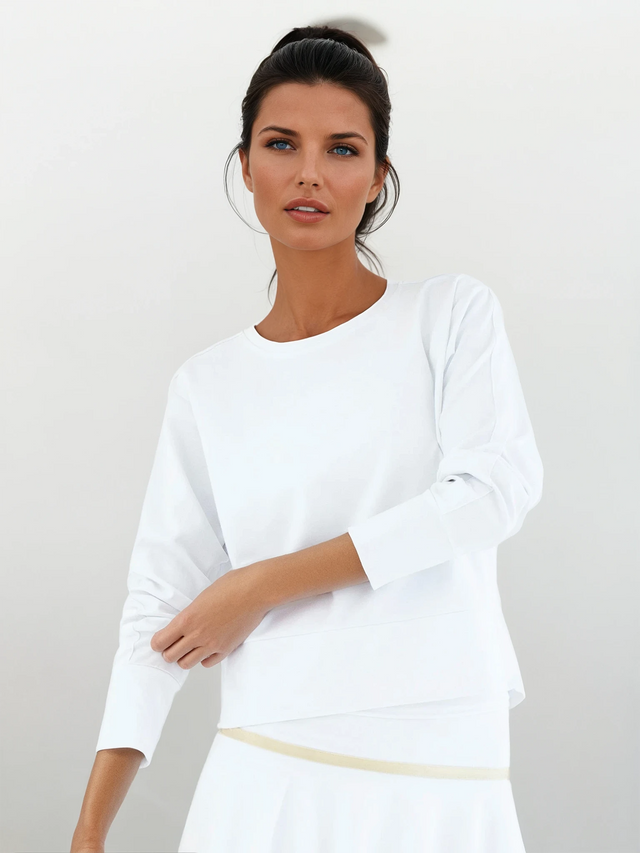 Woman wearing inPhorm Camila Performance sweatshirt in white front view with sleeves pulled up