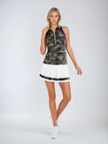 Woman wearing Neisha Classic Sleeveless Polo in camo with silver zip and mesh shoulder inserts, demonstrating the semi-fitted design and ventilation features of this moisture-wicking golf shirt | Full front view.