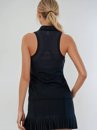 Woman wearing Neisha Classic Sleeveless Polo in black with silver zip and mesh shoulder inserts, demonstrating the semi-fitted design and ventilation features of this moisture-wicking golf shirt | back view.