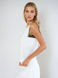 Woman wearing Harper Tank in a relaxed fit with retro-inspired color blocking and contrast accents, showcasing the crew neckline and athletic design suitable for both tennis and casual wear - side front view