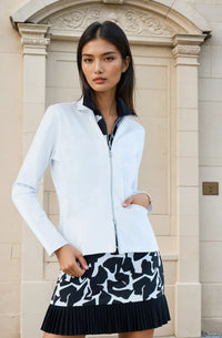 Woman wearing fitted Women's Ultimate Golf Dress with graphic print design and white blazer.  Dress is featuring a 17-inch length, front silver zipper, and side pockets, showcasing the tailored silhouette ideal for golf performance and style. Front full view with blazer.