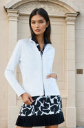 Woman wearing classic-fit Women's Active Blazer in white, showcasing the tailored silhouette with four-way stretch fabric suitable for both professional and active settings.  Front view with jacket worn over a printed dress.