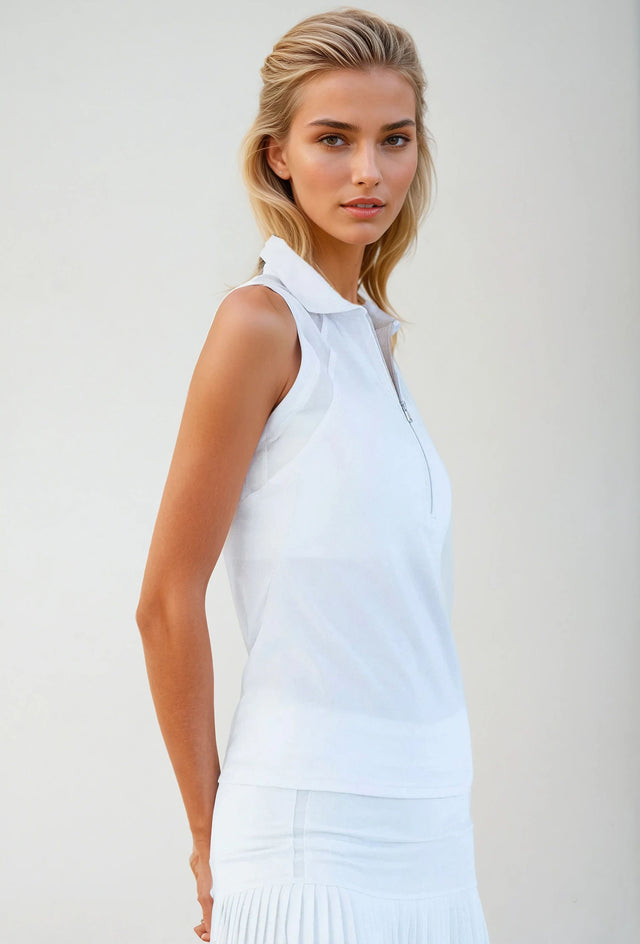 Woman wearing Neisha Classic Sleeveless Polo in white with silver zip and mesh shoulder inserts, demonstrating the semi-fitted design and ventilation features of this moisture-wicking golf shirt | Side View.
