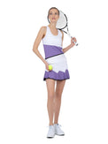 Front view of model wearing the Baseline butterfly skirt in white/lavender combo by inPhorm NYC holding a tennid racket in one hand and a tennis ball in the other