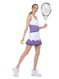 Side view of model wearing the baseline tank in white/lavender combo by inPhorm NYC holding a tennis racket and a tennis ball