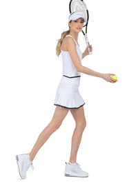 Side view of model wearing the baseline tank in white and black by inPhorm NYC wearing a white visor with her tennis racket up