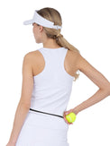 Back view of model wearing the baseline tank in white and black by inPhorm NYC wearing a white visor with her hand on her hip