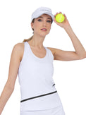 Front view of model wearing the baseline tank in white and black by inPhorm NYC wearing a white hat and holding a yellow tennis ball