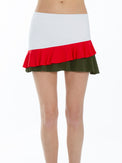 Front view of model wearing the Courtside charm tennis skirt in white poppy and militare by inPhorm NYC