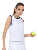 Front view of model wearing the Harper performance tank in white/lavender combo by inPhorm NYC holding a tennis ball