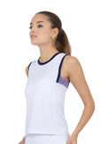 Front view of model wearing the Harper performance tank in white/lavender combo by inPhorm NYC with her hands at her side