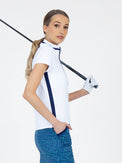 Side view of model wearing the Amelia short sleeve quarter zip top in white/ink by inPhorm NYC holding a golf club over her shoulder