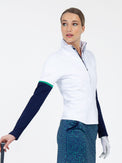 Front view of model wearing the Logan performance long sleeve half zip in white and ink by inPhorm NYC wearing a white glove and holding a golf club