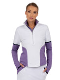 Front view of model wearing the Logan performance half zip jacket in white and lavender by inPhorm NYC wearing white pants with her hands in her pockets