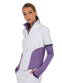 Front view of model wearing the Logan performance half zip jacket in white and lavender by inPhorm NYC with her hands in her pockets