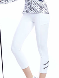 Close up profile view of model wearing the Zone capri leggings in white/midnight/silver by inPhorm NYC