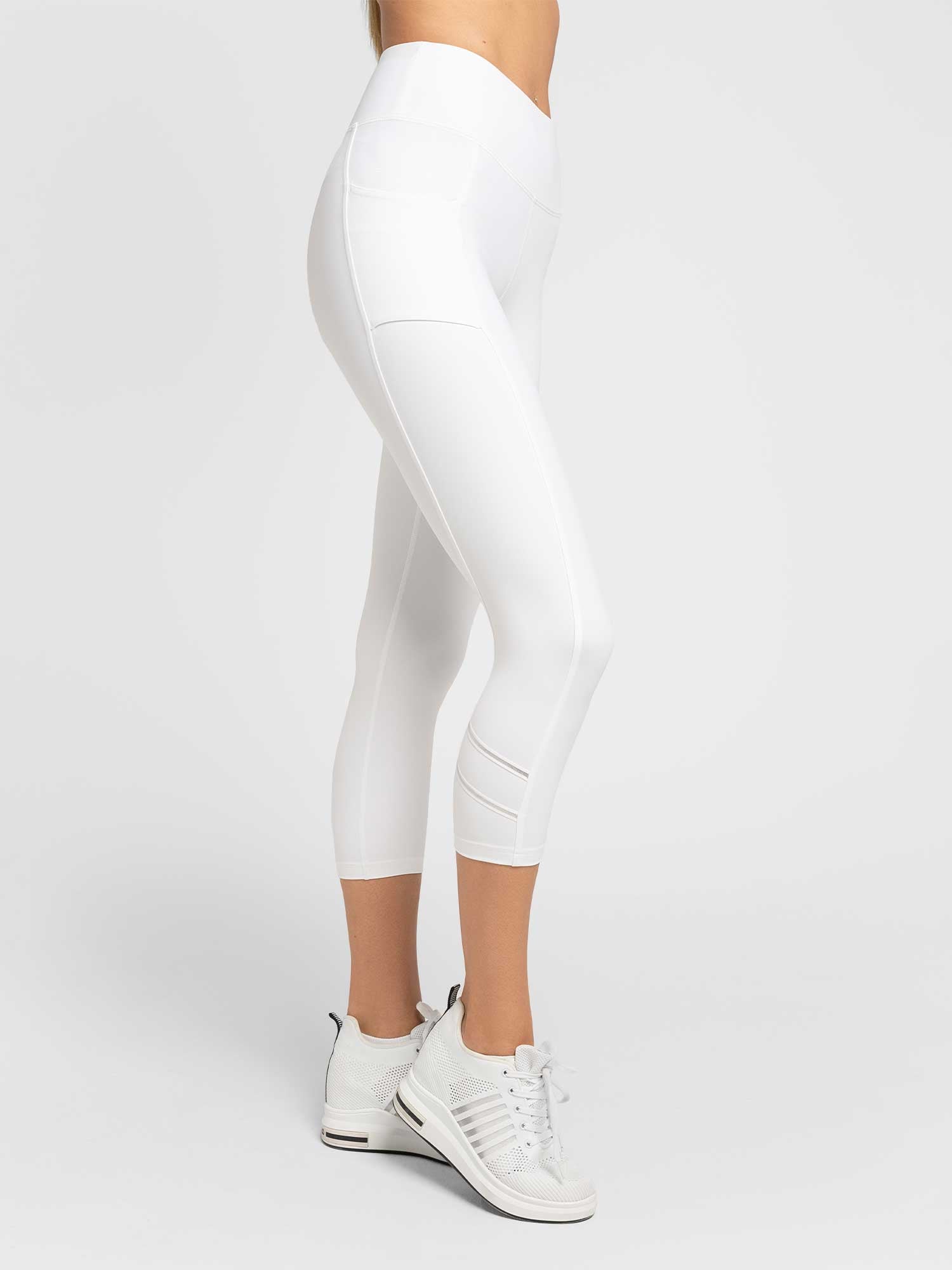 Close up profile view of model wearing the Zone capri leggings in white and silver by inPhorm NYC