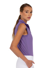 Side view of model wearing the Rhapsody quarter zip sleeveless top in lavender by inPhorm NYC with one hand in her pocket