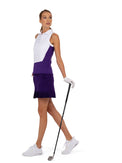 Front view of model wearing the sleeveless golf polo collar top in white and imperial by inPhorm NYC holding a golf club