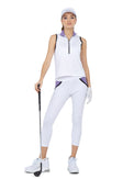 Front view of model wearing the Camilla athleisure capri in white/lavender combo by inPhorm NYC leaning on her gold club