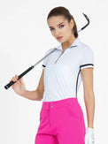 Front view of model wearing the zone short sleeve quarter zip top in white by inPhorm NYC holding a golf club