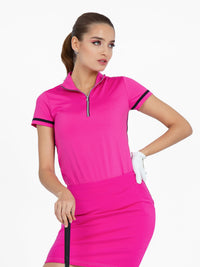 Front view of model wearing the zone short sleeve quarter zip top in pink by inPhorm NYC with one hand on her hip