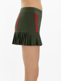 Side view of model wearing the classic 13 1/2" pleated skirt in militaire and poppy by inPhorm NYC