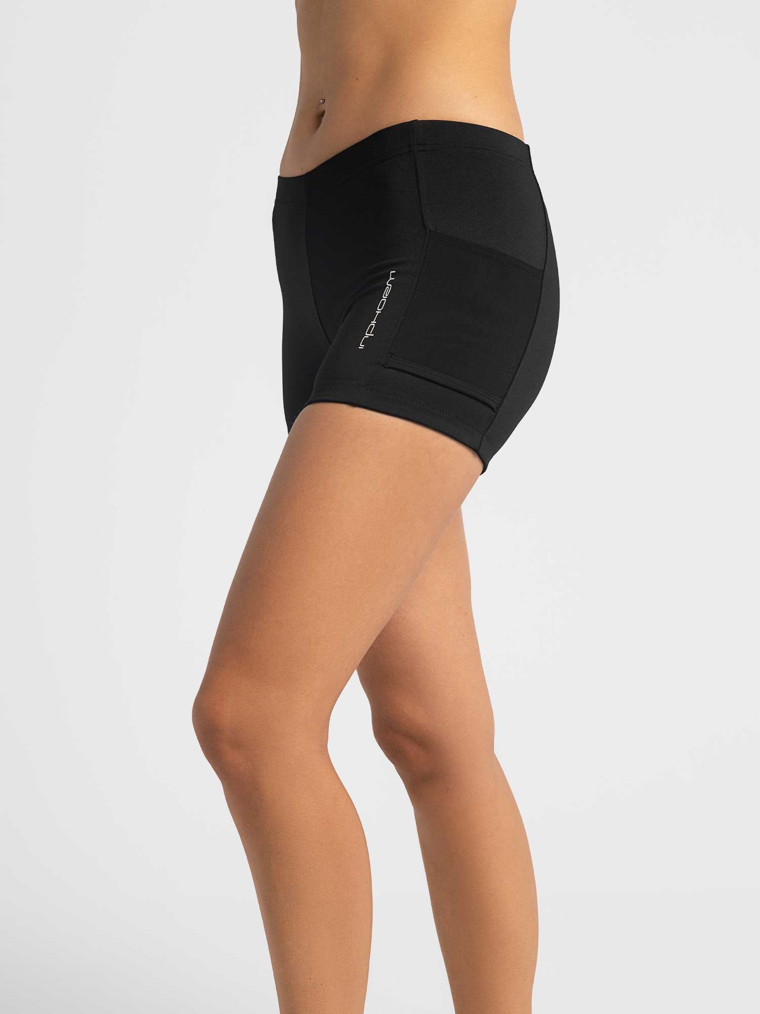 Side view of model wearing the tennis ace shorts in black by inPhorm NYC