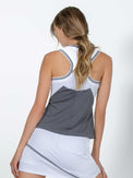 Back view of model wearing the ace your game racer back tank in white and onyx by inPhorm NYC with her hands at her side