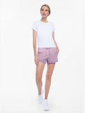 Front view of model wearing the tennis active shorts in lilac by inPhorm NYC with her hand in her pocket