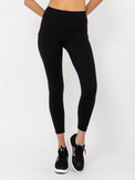 Front view of model wearing the Ashley 7/8 legging in black by inPhorm NYC