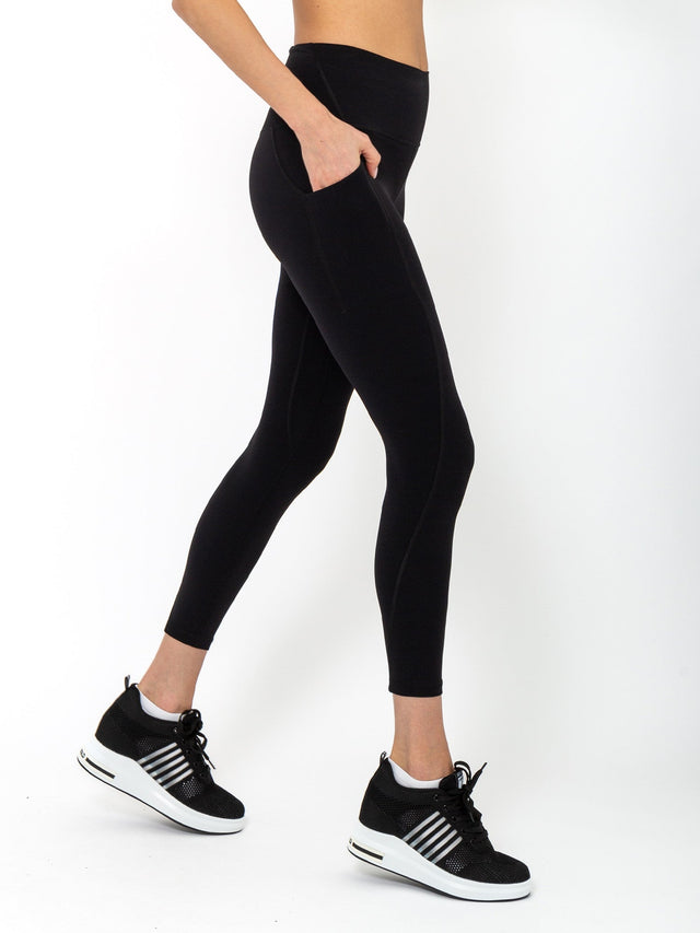 Side view of model wearing the Ashley 7/8 legging in black by inPhorm NYC