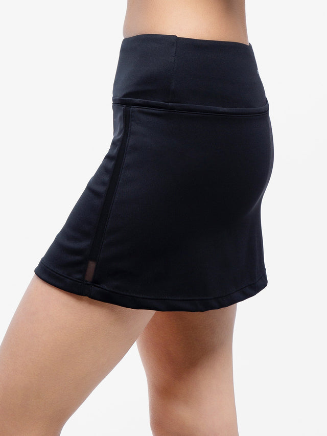 Side view of model wearing the Aubrey 13 1/2" tennis skirt in black by inPhorm NYC