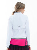 Back view of model wearing the Aubrey lifestyle jacket in white and black by inPhorm NYC with her hands at her side