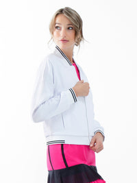 Front view of model wearing the Aubrey lifestyle jacket in white and black by inPhorm NYC with her hand at the zipper