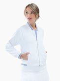 Front view of model wearing the Aubrey lifestyle jacket in white and granite by inPhorm NYC with her hands in her pockets