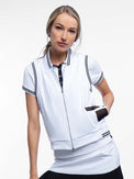 Front view of model wearing the Aubrey lifestyle vest in white and black by inPhorm NYC with one hand in her pocket