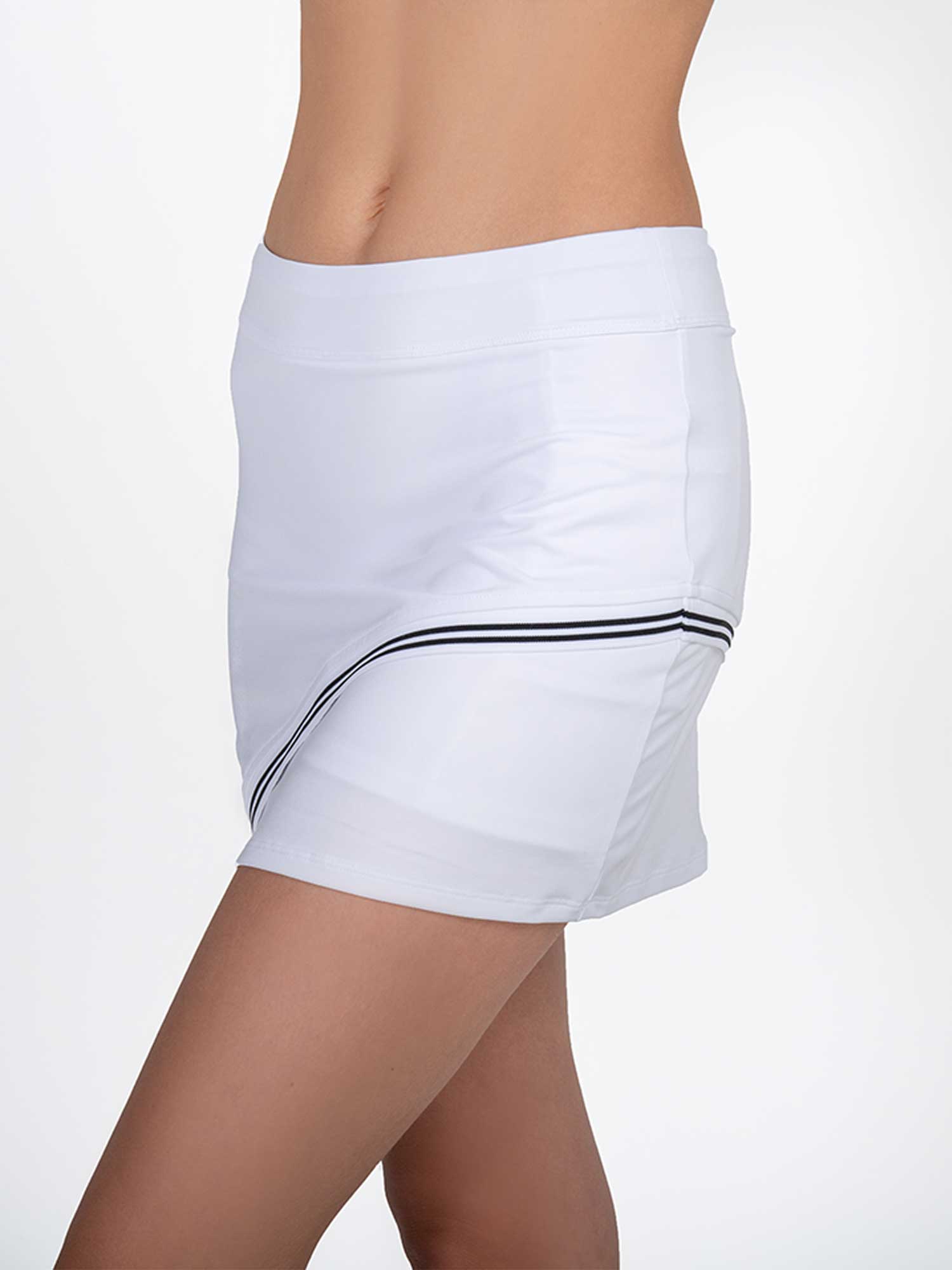 Front side view of model wearing the Chloe 15" asymmetrical skirt in white and black by inPhorm NYC