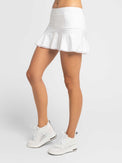 Front view of model wearing the tennis classic 13 1/2" flounce skirt in white by inPhorm NYC