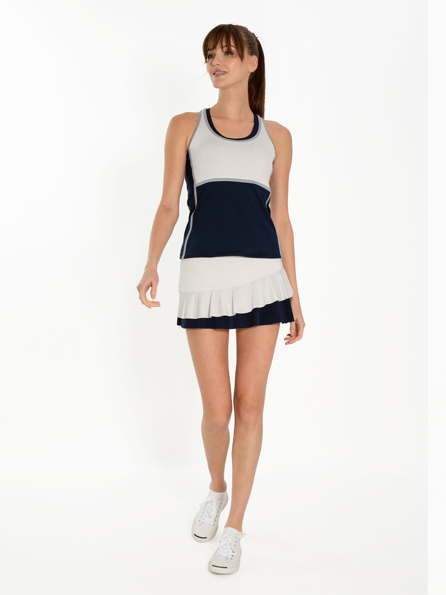 Front view of model wearing the courtside charm tennis skirt in vapor and midnight by inPhorm NYC with her arms at her side